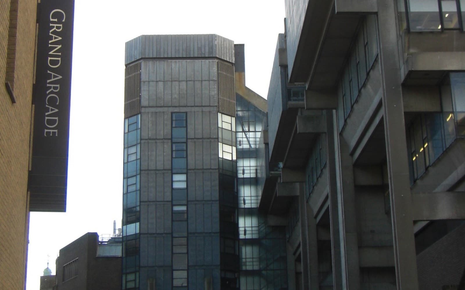 Modern concrete and glass buildings on a narrow street in central Cambridge