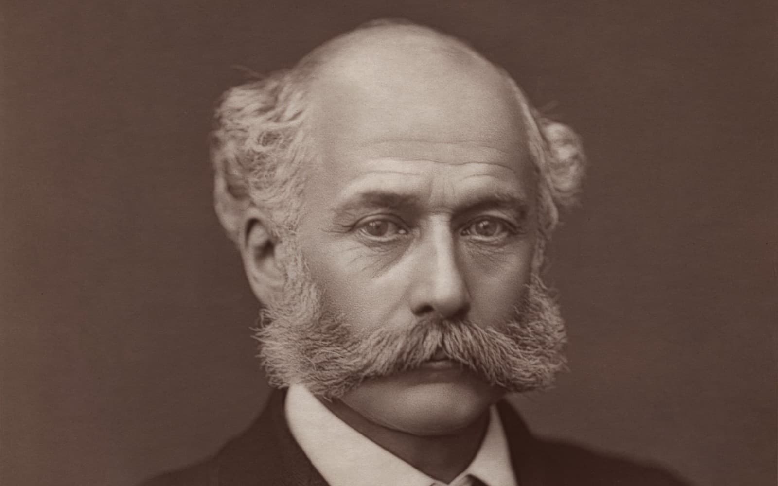 Black and white portrait photograph of Joseph Bazalgette, a bald man with large side whiskers and a moustache